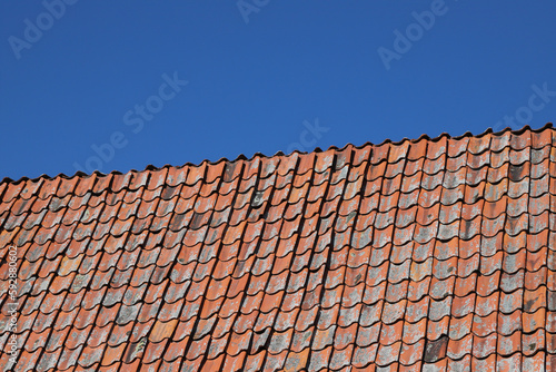 View of a roof covered witth old tiles.