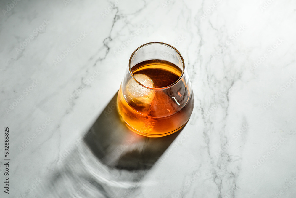 a glass of whiskey with ice