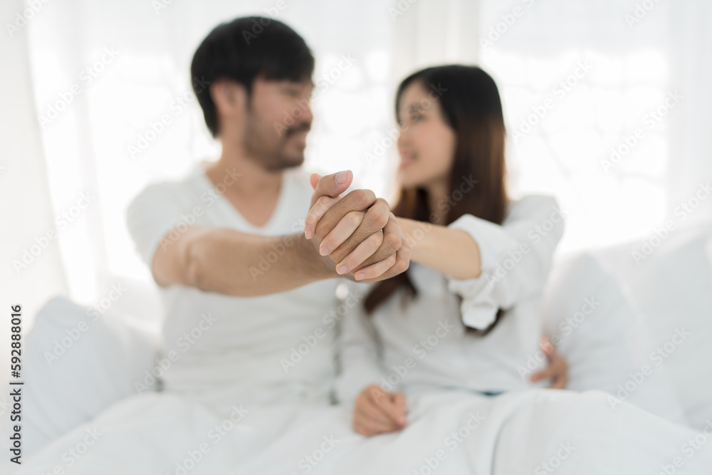 Asian Romantic couple in bed enjoying sensual foreplay Happy sensual young couple lying in bed together. Beautiful loving couple kissing in bed. Asian Romantic couple in bed enjoying sensual foreplay Happy sensual young couple lying in bed together. Beautiful loving couple kissing in bed.