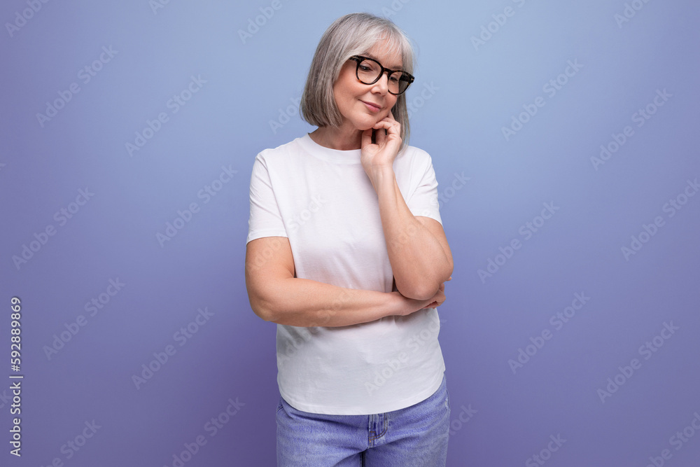 charming 60s woman in white tank top on studio background charming 60s woman in white tank top on studio background