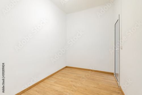 White empty compact room with an entrance door in the room of a mini hotel or a new apartment. The concept of preparation for furnishing and housewarming. Copyspace