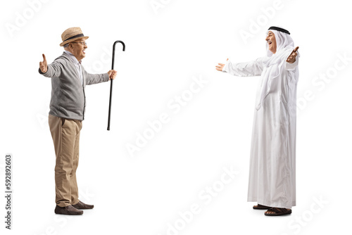 Arab man in traditional muslim clothes walking towards a senior man with arms wide open