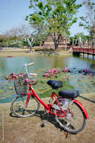 Red Bicycle parked near the lake in Sukhothai historical park