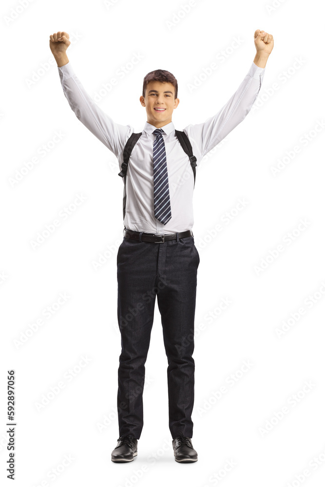 Full length portrait of a happy male student wearing a school uniform and raising arms up Full length portrait of a happy male student wearing a school uniform and raising arms up