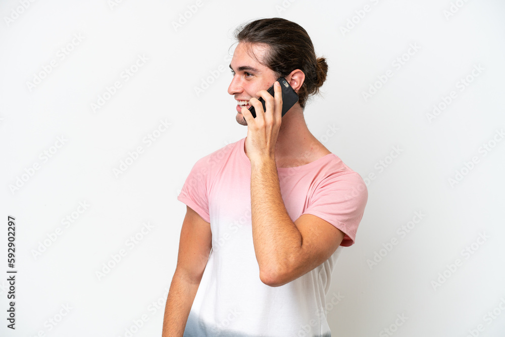 Caucasian handsome man isolated on white background keeping a conversation with the mobile phone with someone Caucasian handsome man isolated on white background keeping a conversation with the mobile phone with someone