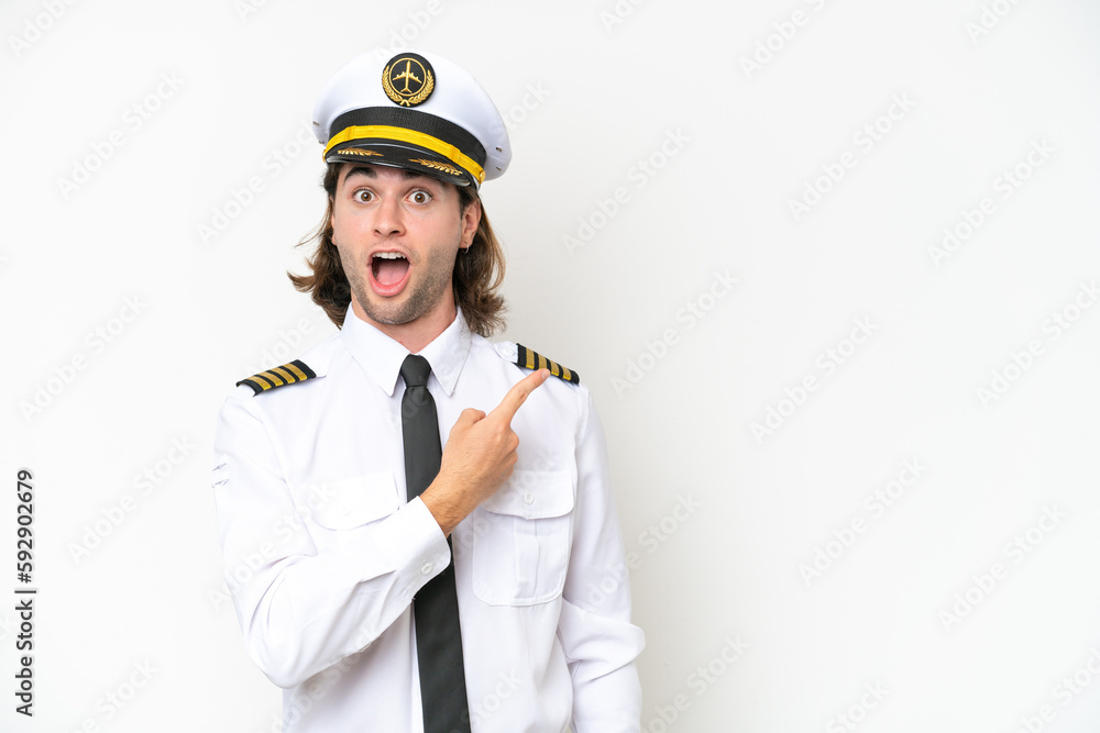 handsome Airplane pilot isolated on white background surprised and pointing side handsome Airplane pilot isolated on white background surprised and pointing side