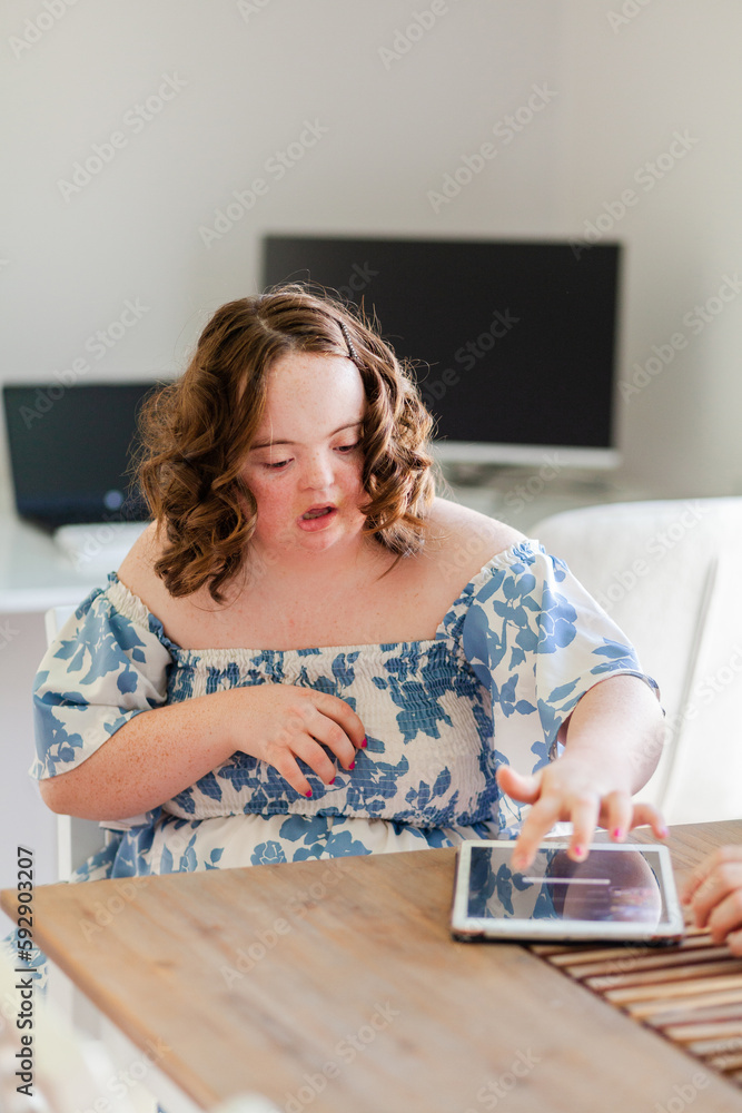 Portrait of a teenager using tablet device at table Portrait of a teenager using tablet device at table