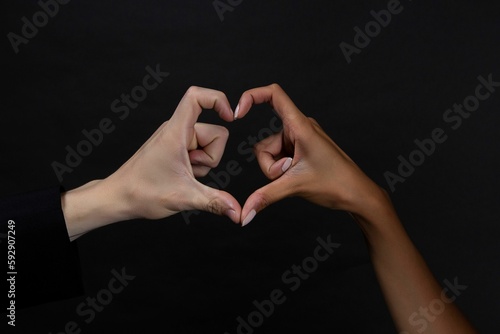 People belonging to different races making a heart with their hands