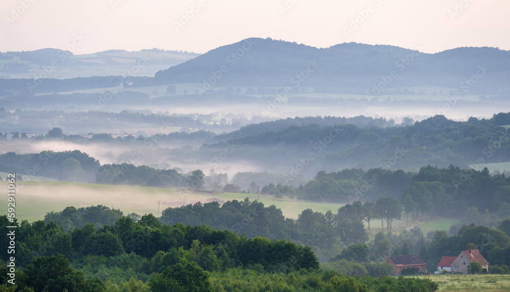 view on misty hills in Kaczawskie mountains in Poland