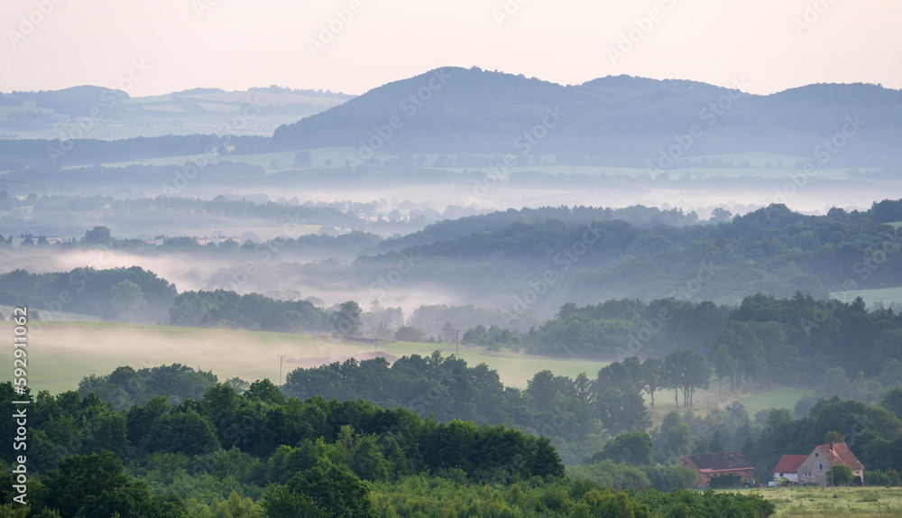 view on misty hills in Kaczawskie mountains in Poland