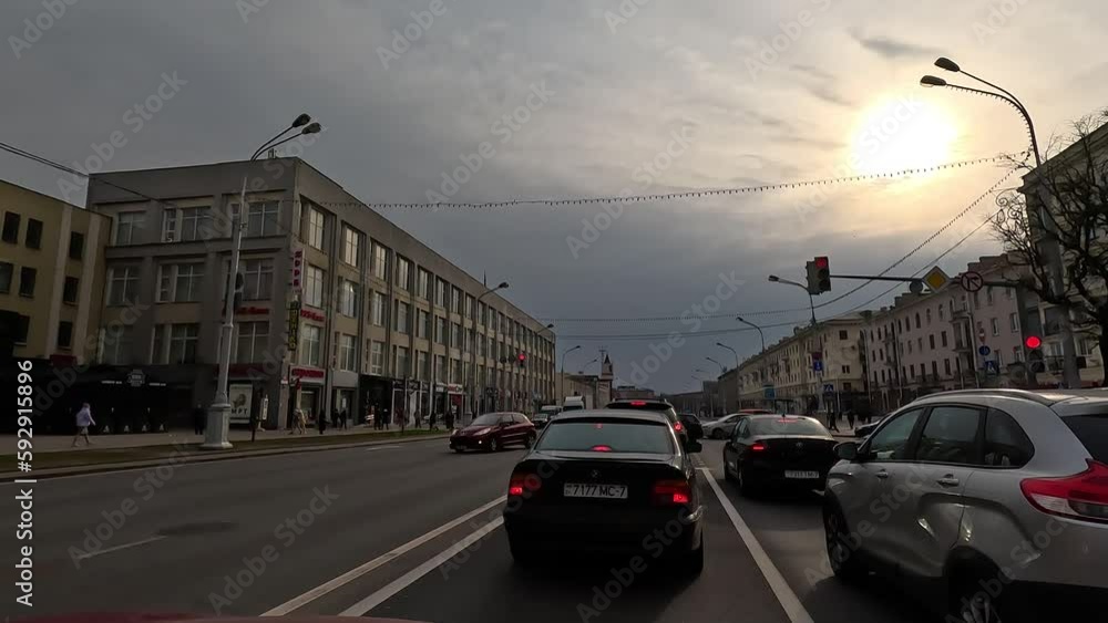 The car drives along the road in the city street on a summer day. Highways, road line markings and cars. The car drives along the road in the city street on a summer day. Highways, road line markings and cars.