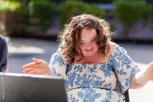 Happy seventeen year old girl with a disability doing a joyful dance move photo