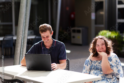 Happy young person with disability doing one on one activity with her NDIS provider photo