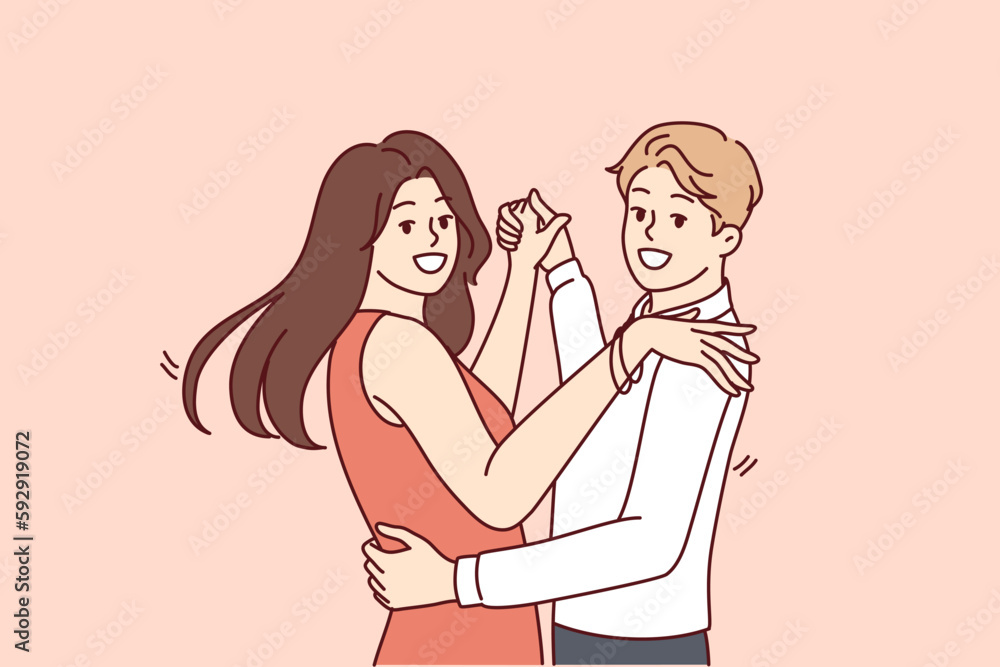 Man and women dancing bachata or salsa wish to become professional latin dancers and embracing partner looking at camera. Happy couple of guys and girls dancing to music in club or on dance floor 