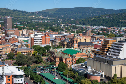 A mid view of the city hall and buildings in downtown Pietermaritzburg, Kwazulu-Natal, with suburbs and hills in the background.