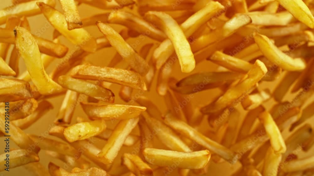Super slow motion of flying French fries on yellow background. Filmed on high speed cinema camera, 1000 fps. Camera placed on high speed cine bot, tracking the target. Super slow motion of flying French fries on yellow background. Filmed on high speed cinema camera, 1000 fps. Camera placed on high speed cine bot, tracking the target.