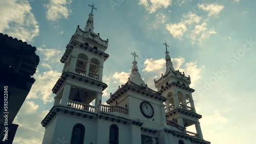 Low angle time lapse footage of Parroquia de San Cristobal Catholic church in Mazamitla, Mexico photo
