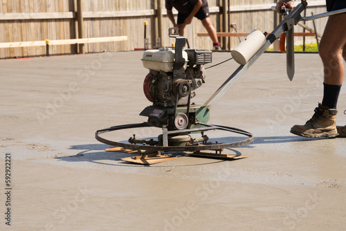 A concreting helicopter bveing used to put the final finish on a concrete slab in tropical North Queensland.