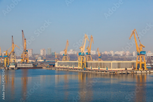 Port cranes on the territory of the seaport in Constanta Romania with blue sky. Territory of the seaport with cranes.