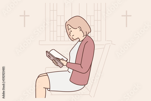 Christian woman is reading bible sitting on pew in empty church wishing to receive absolution