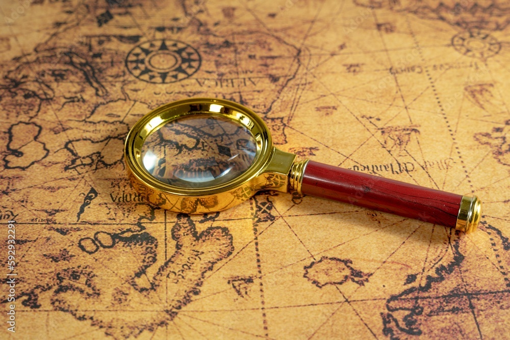 Magnifier put on the map - concept of adventures and traveling
