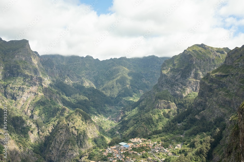 Aerial view of Curral das Freiras in Madeira Island with a cloudy sky in the background, Portugal