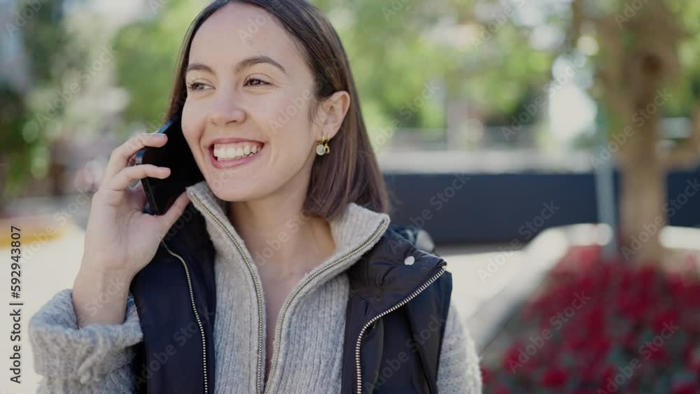 Young beautiful hispanic woman smiling confident talking on smartphone at park Young beautiful hispanic woman smiling confident talking on smartphone at park