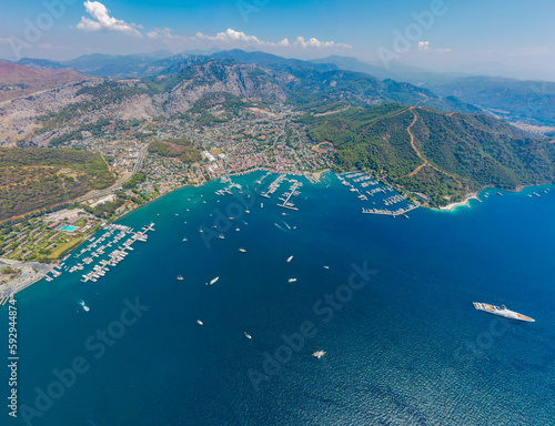 Aerial drone photo of the bustling Göcek Marina, located in the beautiful coastal town of Muğla, Turkey, captured by a drone showcasing the vibrant harbor and surrounding landscape.