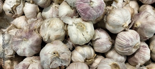 Garlic on display in a market stall close-up.