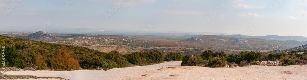Panoramic shot of the Dalmatian landscape from a hill against a blue sky