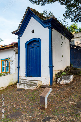 Sabará. Beautiful colorful old mansions in the historic city of Sabará. Brazil. Blue sky. Stone-paved street. © Edson