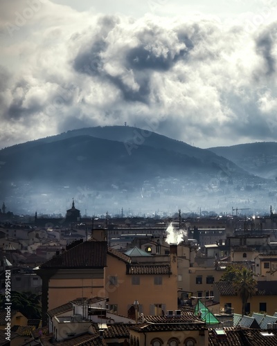 Vertical high-angle of Florence cityscape on a gloomy day with misty background