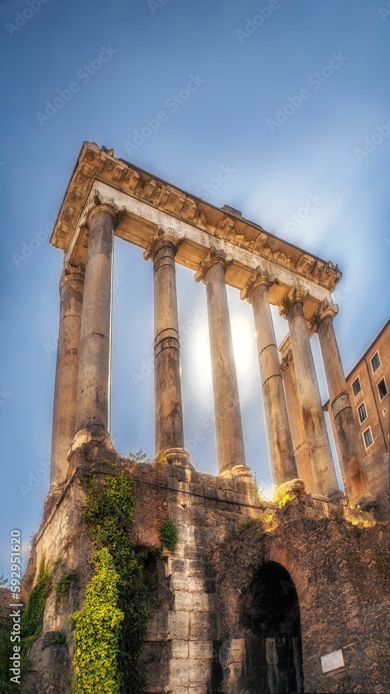 Vertical low-angle of ruins of the temple of Saturn with long exposure effect