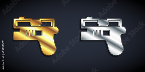 Gold and silver Futuristic space gun blaster icon isolated on black background. Laser Handgun. Alien Weapon. Long shadow style. Vector