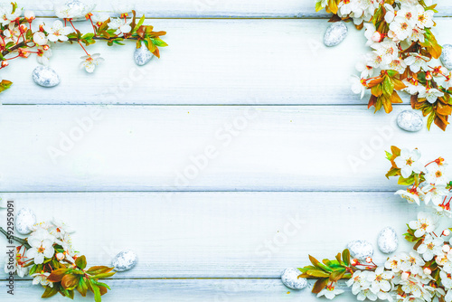 Easter spring background. Sakura flower, white happy easter egg on wooden spring background. Easter wallpaper. Spring holiday concept.