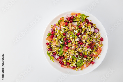 Obraz na płótnie Sprouting green gram bean Indian salad with Onion, coriander leaf , green chilli , Pomegranate and tomatoes. Indian sprouting gram bean salad with isolated background, Healthy eating concept. ... w salonie