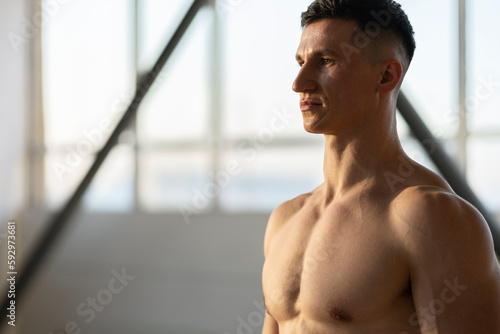 Attractive muscular latin man, athlete, indoors. Healthy lifestyle concept, copy space