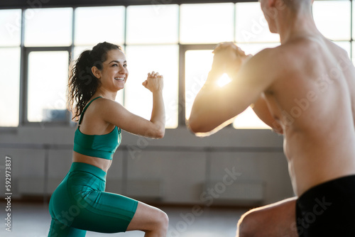 Smiling, handsome woman and man exercising in gym, healthy lifestyle concept photo