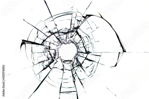 Cracks in the glass from a bullet on a white background