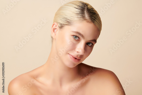 Beautiful young woman with clean fresh skin on beige background, Face care, Facial treatment, Cosmetology, beauty and spa,