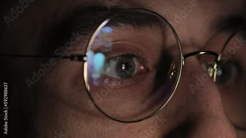 Internet Addiction, Phone Screen, Brainwashing, Web Surfing, Fake News. Media deception. smartphone screen is reflected in glasses. men's eyes in glasses close-up, watch the news on the smartphone