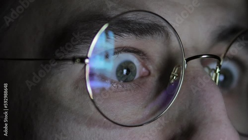 Internet Addiction, Phone Screen, Brainwashing, Web Surfing, Fake News. Media deception. smartphone screen is reflected in glasses. men's eyes in glasses close-up, watch the news on the smartphone