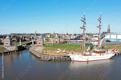 Aerial from the historical city Lemmer with an old traditional sailing ship in Friesland the Netherlands