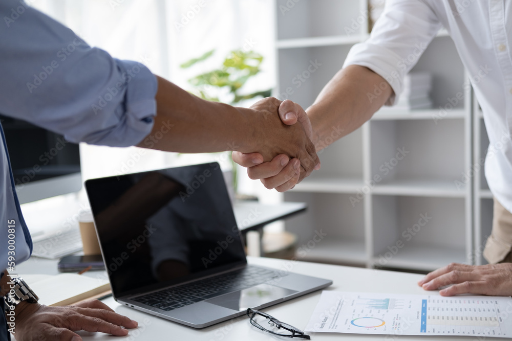 Close-up two businessmen shaking hands after a successful result meeting. Close-up two businessmen shaking hands after a successful result meeting.