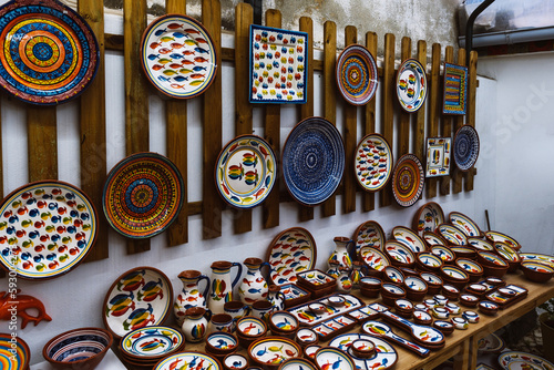 Collection of colorful pottery from a local craft store on display. Handmade ceramic gift shop in Lisbon, Portugal