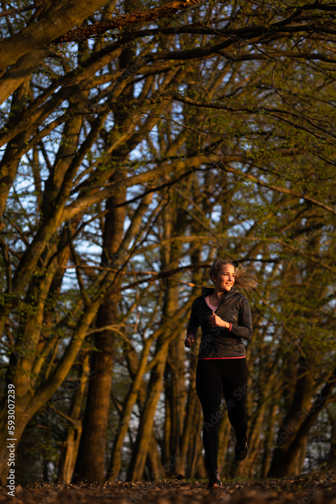 Pretty, young woman with running outdoors on a spring day Pretty, young woman with running outdoors on a spring day