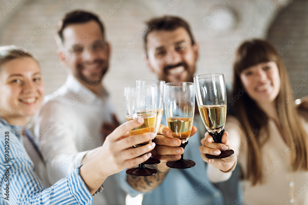 Close up of group of business people having fun and toasting with white wine Close up of group of business people having fun and toasting with white wine