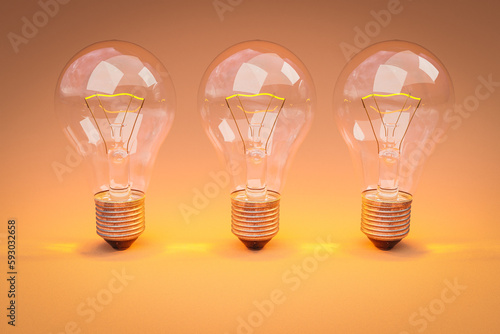 Foto three retro style lightbulbs with glowing filament standing in a row on infinite