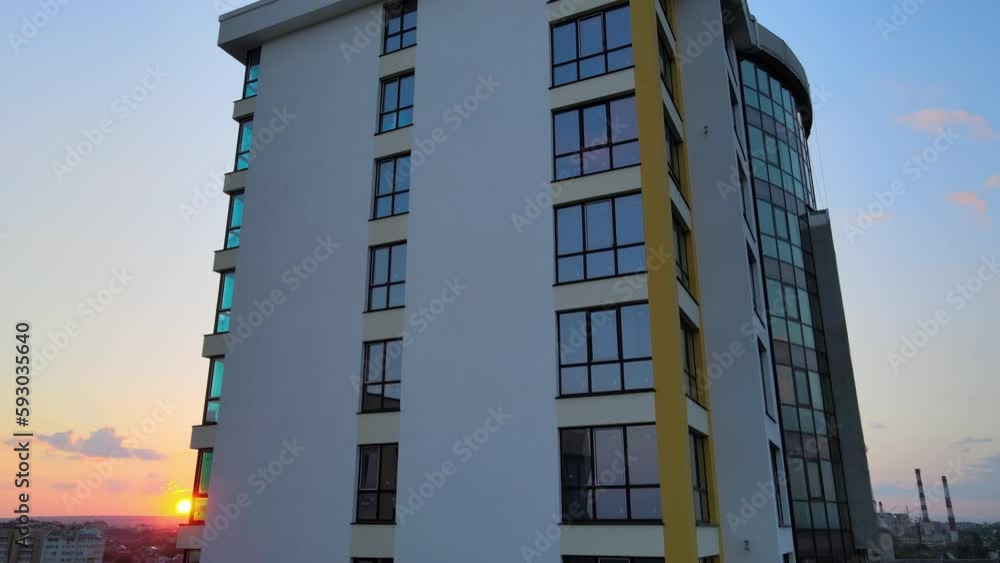 High rise residential apartment building in city residential area at sunset. Real estate development High rise residential apartment building in city residential area at sunset. Real estate development