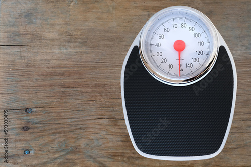 floor mechanical scales in vintage style, scale with red arrow in circle in circle, top view, the concept of weight control, human physical health, diet and nutrition, lose weight